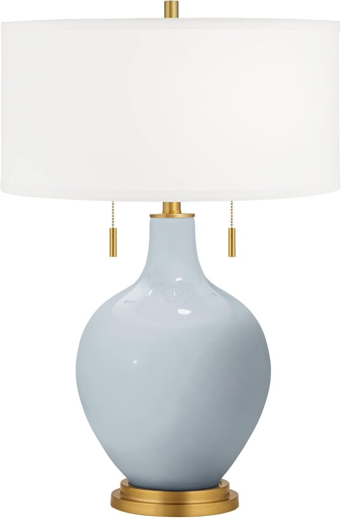 Light blue lamp with gold accents and white shade